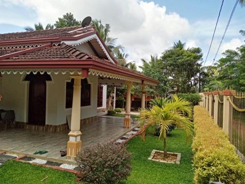 a house with a garden and a fence at Blessing Home in Badalgama
