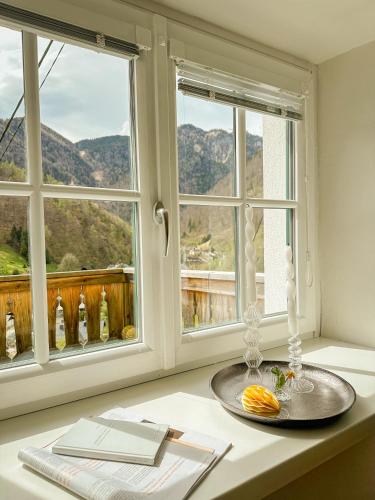a table with a plate and two windows at Ferienhaus Alexandra in Ebensee in Ebensee
