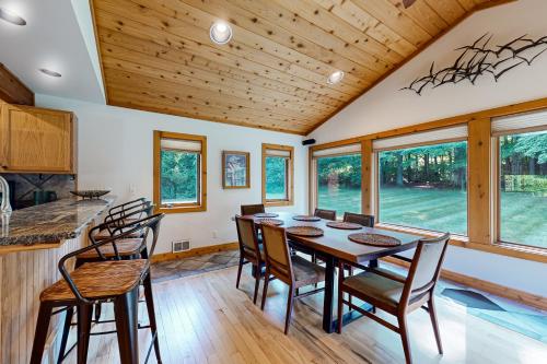 a dining room with a table and chairs at Trout Lily Cabin in Beulah