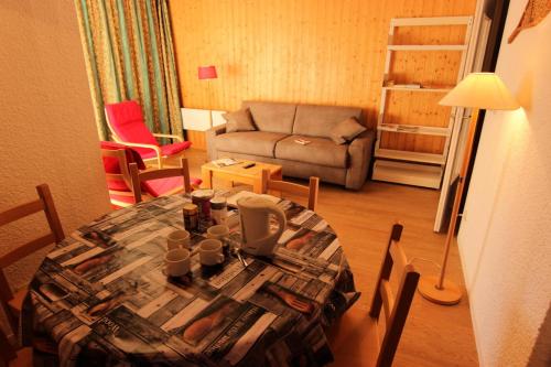 un salon avec une table et un canapé dans l'établissement Résidence Lac Du Lou - VAL THORENS APPARTEMENT 6 PERSONNES SPACIEUX ET CONFORTABLE MAE-7456, à Val Thorens