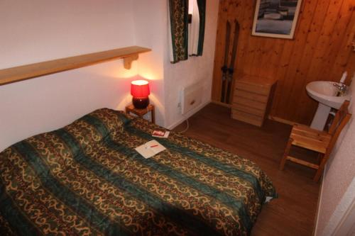 une chambre d'hôtel avec un lit et un lavabo dans l'établissement Résidence Lac Du Lou - VAL THORENS APPARTEMENT 6 PERSONNES SPACIEUX ET CONFORTABLE MAE-7456, à Val Thorens