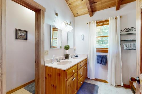 a bathroom with a sink and a mirror at View Paradise in Boone