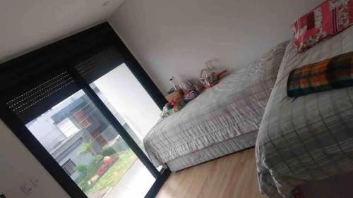 a bedroom with a large window and a bed at Condomínio Blue: O Paraíso que Você Merece! in Xangri-lá