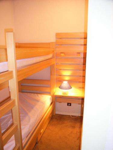 Cette petite chambre comprend 2 lits superposés et une lampe. dans l'établissement Résidence Serac - 2 PIECES CABINE POUR 4 PERSONNES EXPOSE SUD AU SEIN DU QUARTIER SLALOM MAE-7577, à Val Thorens