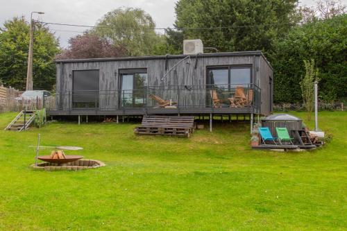 una casa pequeña sentada en un campo de hierba en Meerbeek Unwind, en Kortenberg