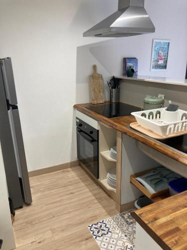 a kitchen with a counter top and a stove at Gîte la peille in Cordemais
