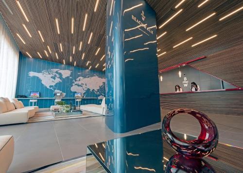 a lobby with a glass table with a red vase on it at Penthouse Sky Suite - 2BDR2BTH - Private Rooftop Terrace in Hallandale Beach