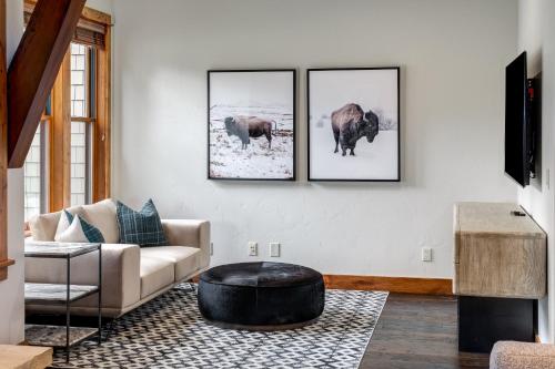 a living room with three pictures of animals on the wall at The Porches in Steamboat Springs