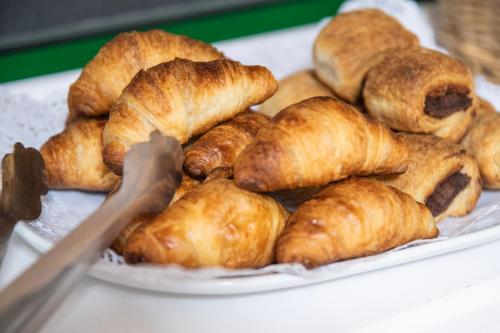 a pile of pastries on a plate on a table at Hotel Apartamentos Villa Gomera in San Sebastián de la Gomera