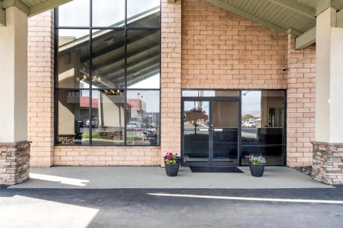 a brick building with two potted plants in front of it at Americas Best Value Inn Yakima in Union Gap