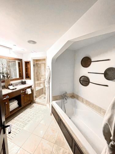a large bathroom with a tub and a sink at Luxury Auberge Madeline Residence Building in Telluride