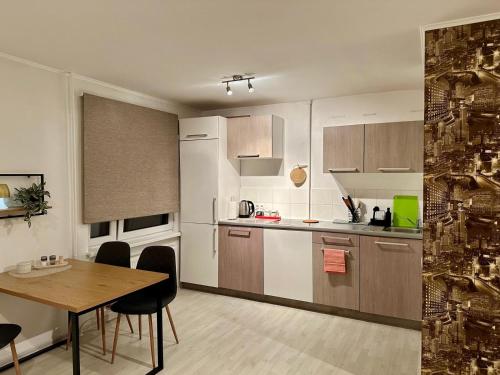 a kitchen with a table and a dining room at Saule in Ventspils