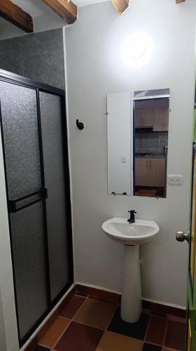 a bathroom with a sink and a mirror at ALOJAMiENTO RURAL LA BELLA ALCUDIA in Quimbaya
