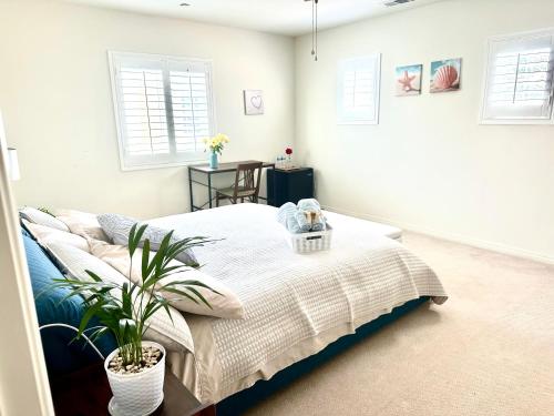 a bedroom with a bed and a potted plant at This listing is not availabl in Eastvale