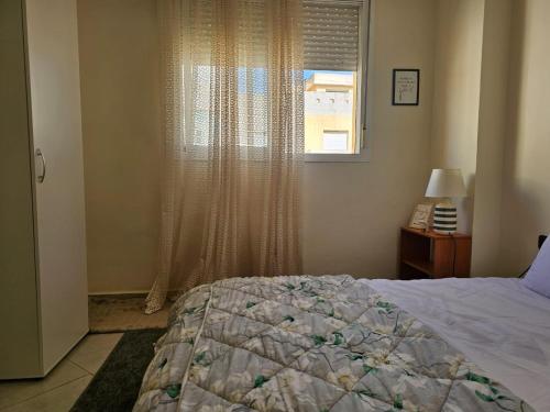 a bedroom with a bed and a window at appartement confortable in Branes