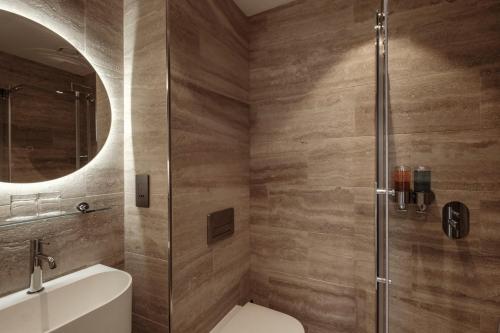 a bathroom with a shower and a toilet and a sink at San Karlu in Valletta