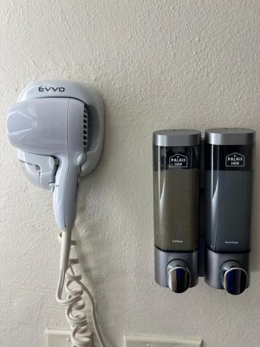 a hair dryer and a hairdryer on a wall at Palace Inn I-45 & Bellfort in Houston