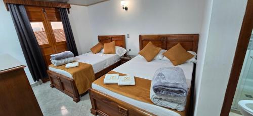 Postel nebo postele na pokoji v ubytování HOTEL EL VALENCIA