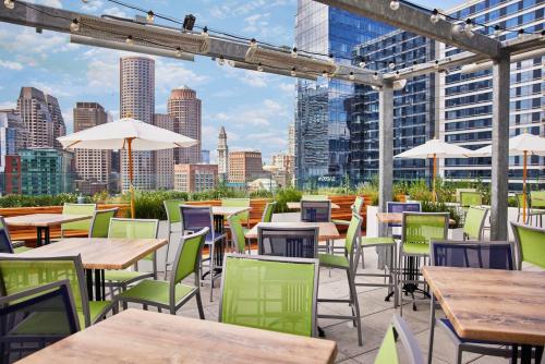 a patio with tables and chairs and a view of the city at YOTEL Boston in Boston