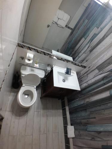 a bathroom with a white toilet and a sink at Contemporary One Bedroom at Sandcastles in Ocho Rios