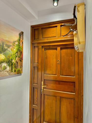 Una puerta de madera en una habitación con una pintura. en Blancris Boutique, en Brasov