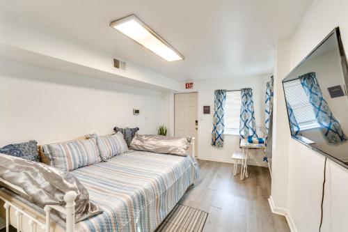 a living room with a couch and a tv at Daytona Beach Studio Walk to Boardwalk and Pier! in Daytona Beach