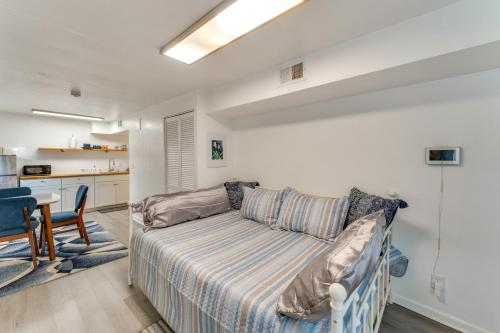 a living room with a couch and a kitchen at Daytona Beach Studio Walk to Boardwalk and Pier! in Daytona Beach