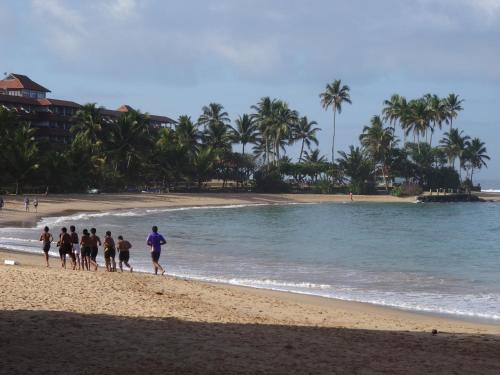 a group of people walking on the beach at Chami's Place in Hikkaduwa