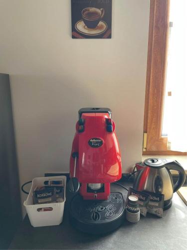 a red mixer sitting on top of a counter at Casa dei pazzi Montanari da Cristina in Alfedena