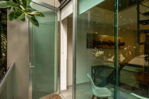 a glass room with a chair next to a window at JTowers in Mexico City