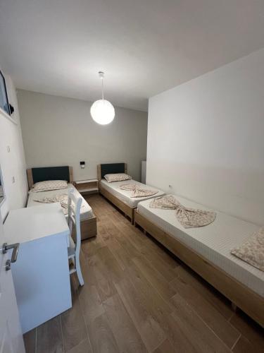 a room with three beds in a room at Best Summer Apartment in Golem
