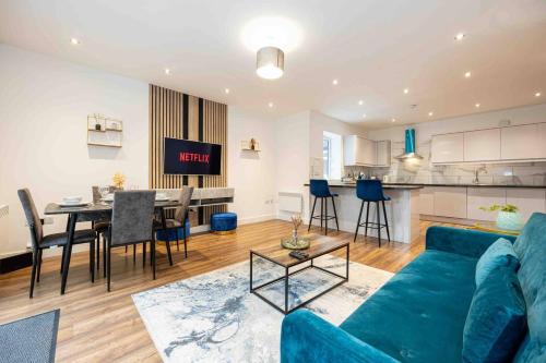 a living room with a blue couch and a table at Vibrant 2br Apartment In Chorlton, Free Parking in Manchester