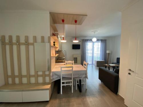a kitchen and living room with a table and chairs at Best Summer Apartment in Golem