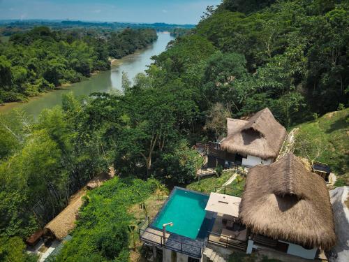 an aerial view of a resort with a river at Refugio Monte Oscuro in Las Mercedes