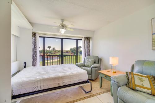 a bedroom with a bed and a couch and a window at 2 Mi to Fort Pierce Jetty Coastal Florida Condo in Fort Pierce