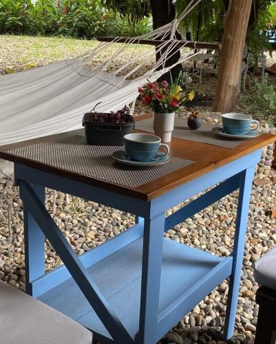 a table with two cups on top of it at casa lumka hotel boutique spa in Mariquita