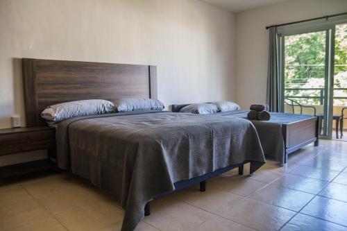 a bedroom with a large bed with a wooden headboard at Creuza de Mä in Playa del Carmen