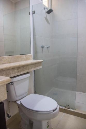 a bathroom with a toilet and a glass shower at Creuza de Mä in Playa del Carmen
