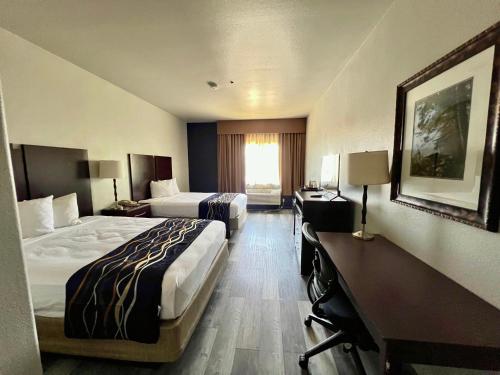 a hotel room with two beds and a window at Budget Inn Phoenix in Phoenix