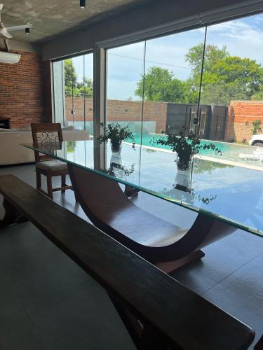 a glass table in a room with a large window at Casa de verano en San Bernardino in San Bernardino