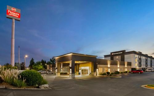 a building with a sign in a parking lot at Best Western Premier Richmond City Gateway in Richmond