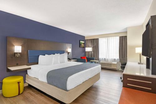 Pokój hotelowy z dużym łóżkiem i niebieską ścianą w obiekcie Best Western Premier Richmond City Gateway w mieście Richmond
