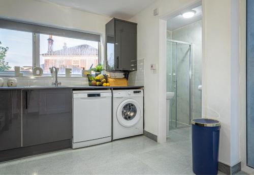 a kitchen with a washing machine and a sink at The Hive in Coventry