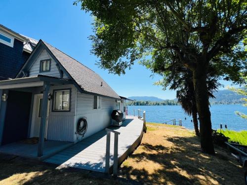 a small house on a dock next to a lake at Lake Sammamish Waterfront Cabin in Sammamish