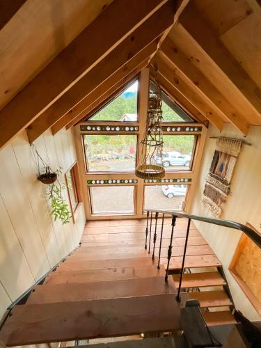 a staircase in a tiny house with a large window at La Colmena eco lodge in Ensenada