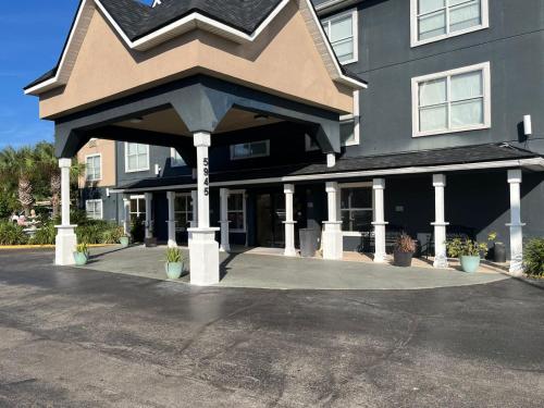 a large building with an awning in a parking lot at Country Inn & Suites by Radisson, Jacksonville, FL in Jacksonville