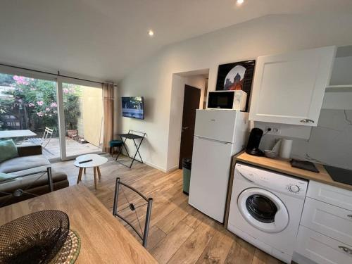 Il comprend une cuisine et un salon avec une table et un lave-linge. dans l'établissement Le Duo Cosy Parking, à Carcassonne