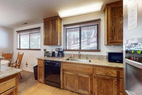 a kitchen with wooden cabinets and a sink at High Meadows Retreat in South Lake Tahoe