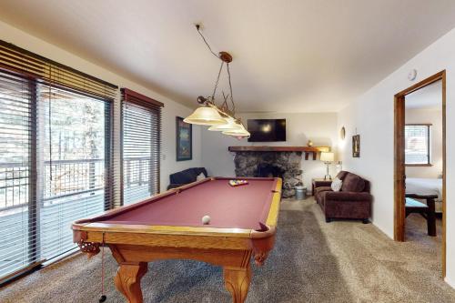 a living room with a pool table and a fireplace at High Meadows Retreat in South Lake Tahoe