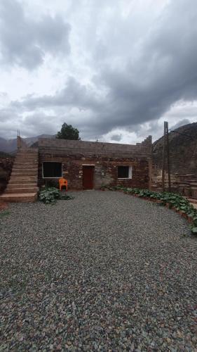 a brick building with a staircase in front of it at Tayda Guest House in Azilal